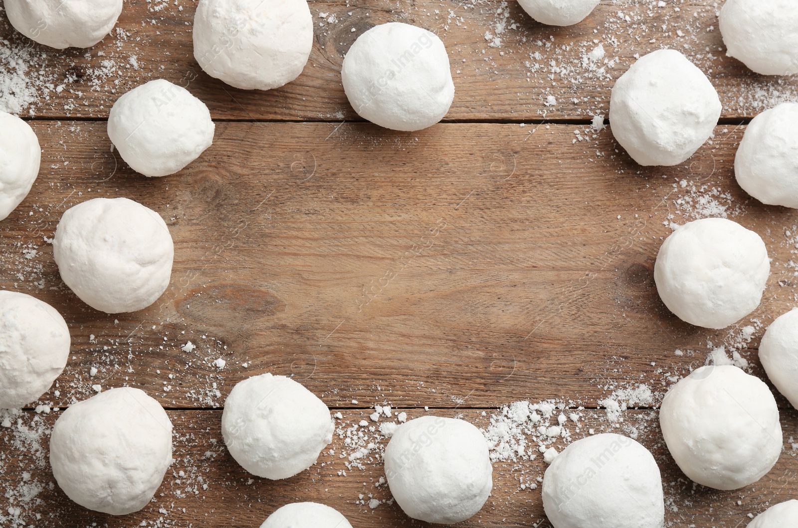 Photo of Frame of snowballs on wooden background, flat lay. Space for text