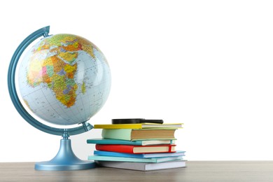 Globe, school supplies and magnifying glass on wooden table against white background. Geography lesson