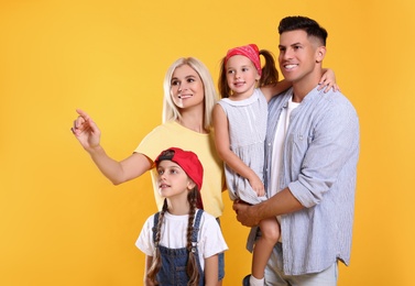 Portrait of happy family on yellow background