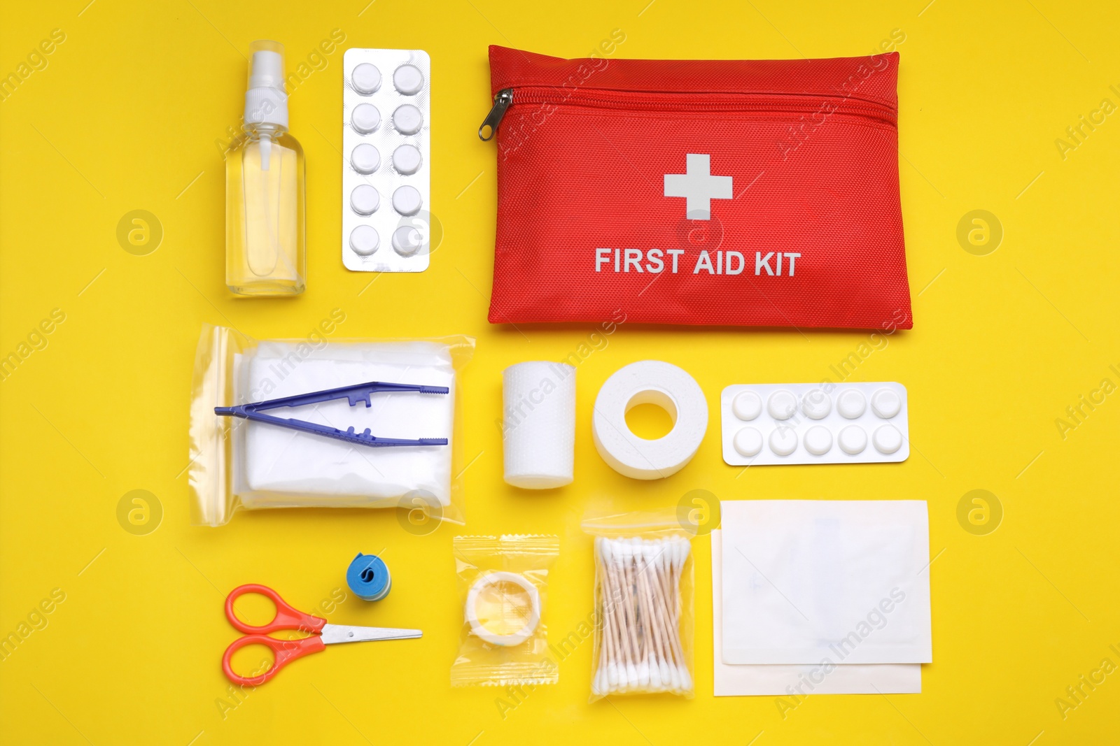 Photo of Flat lay composition with first aid kit on yellow background