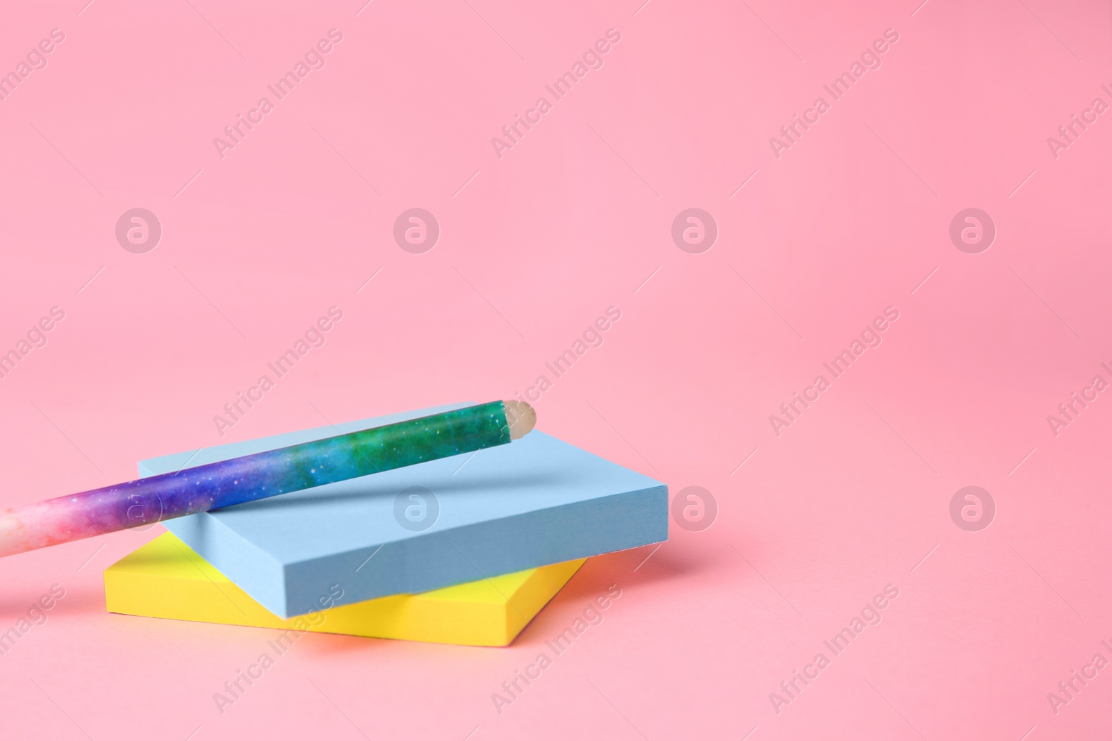Photo of Colorful paper notes with erasable pen on pink background. Space for text