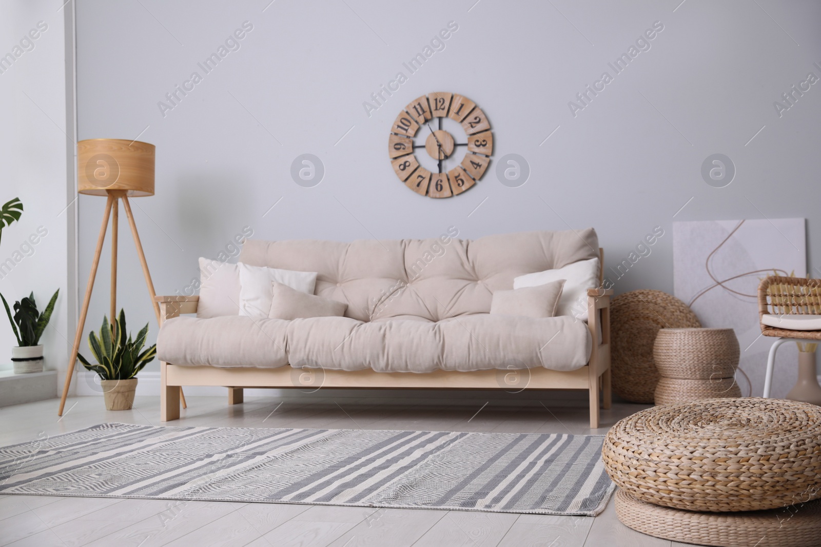 Photo of Cozy living room interior with stylish beige sofa