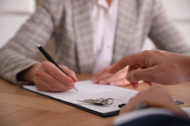 Photo of Real estate agent working with client in office, closeup