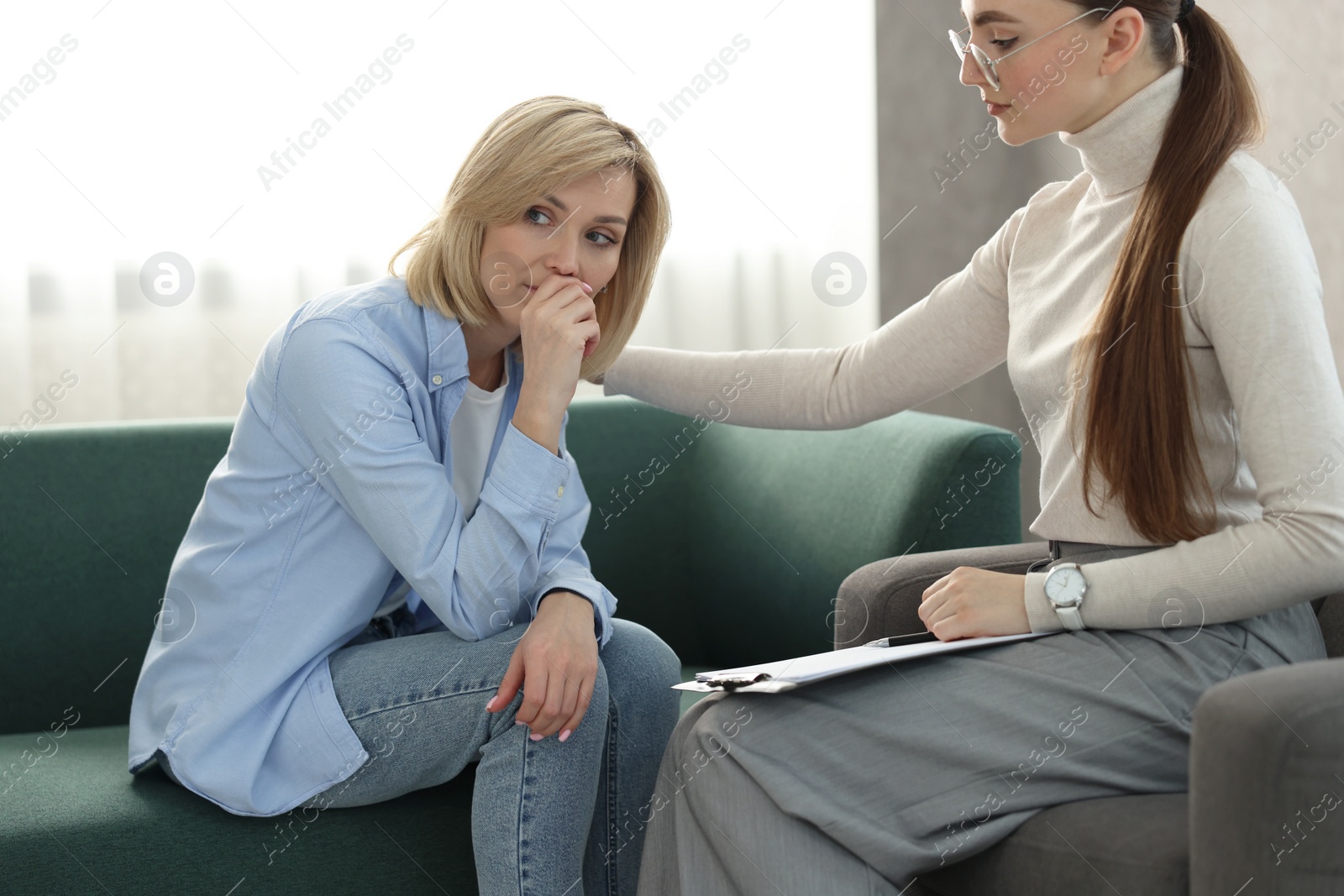 Photo of Professional psychotherapist working with patient in office