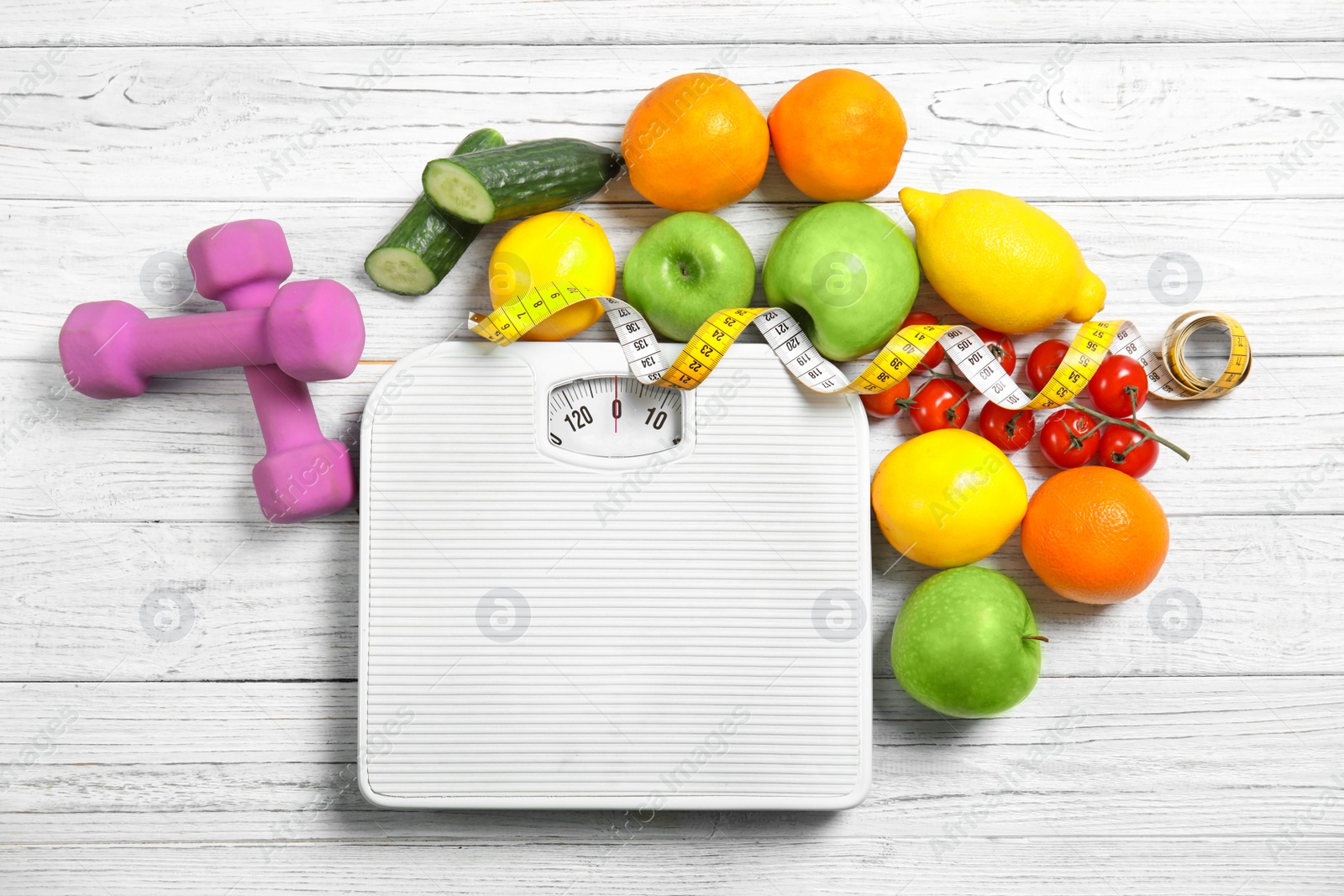 Photo of Flat lay composition with scales, healthy food, measuring tape and dumbbells on wooden background. Weight loss