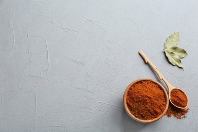 Photo of Ground red pepper on grey table, top view. Space for text