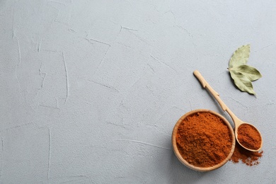 Ground red pepper on grey table, top view. Space for text