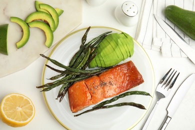 Photo of Tasty cooked salmon and vegetables served on white table, flat lay. Healthy meals from air fryer