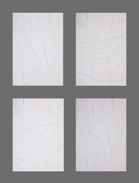 Image of Collection of creased blank posters on grey background