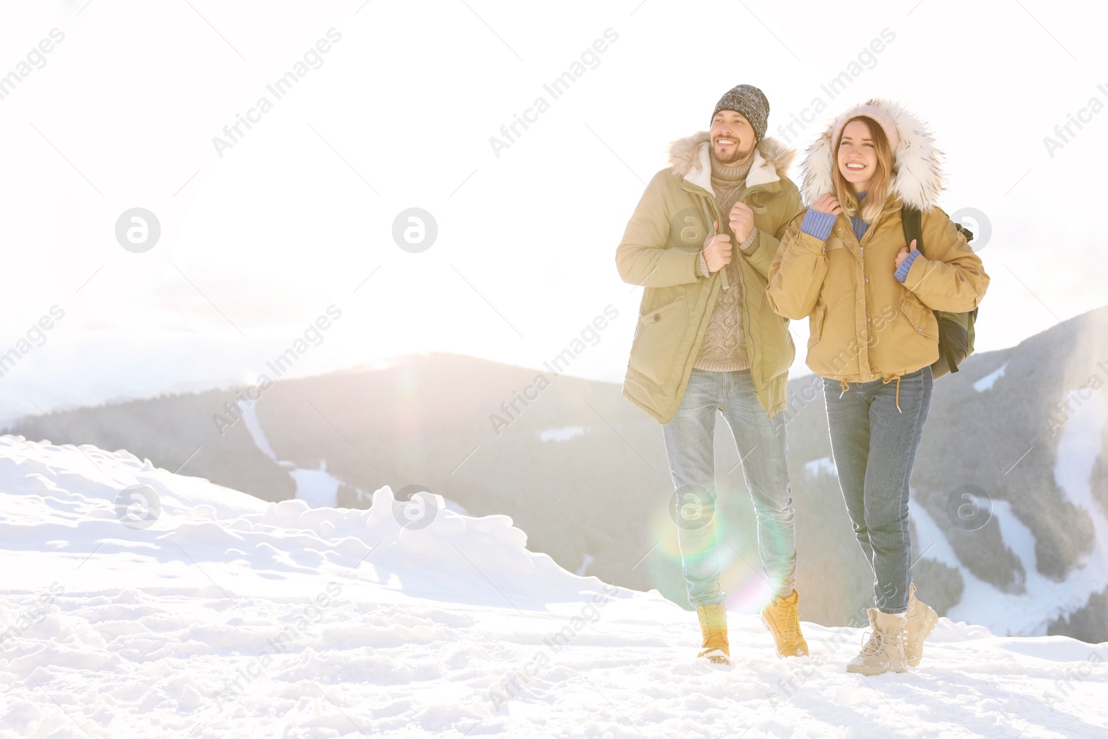 Photo of Happy couple spending winter vacation together in mountains. Space for text