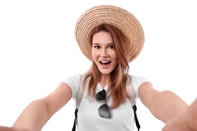 Beautiful woman in straw hat taking selfie on white background