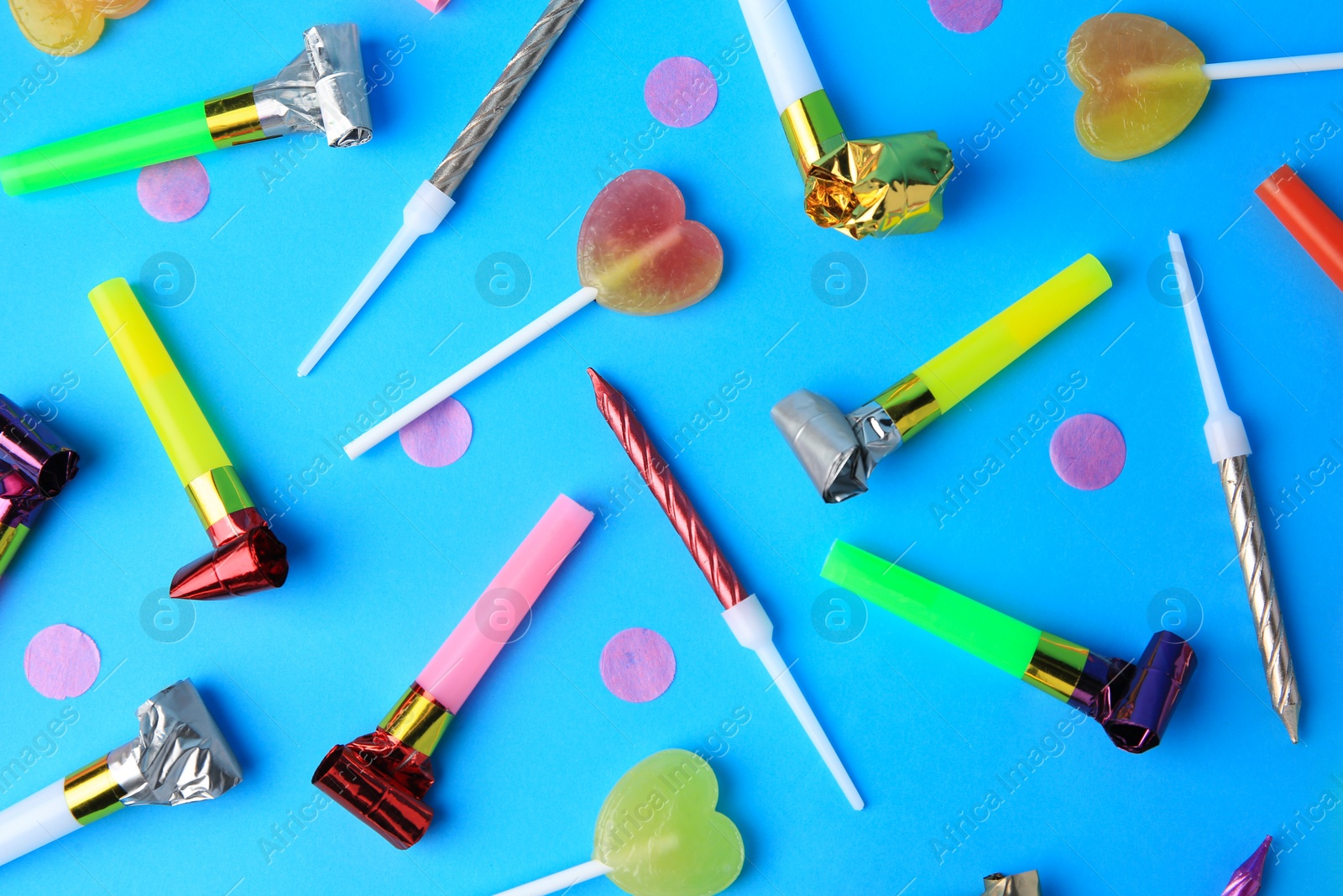 Photo of Many different party items on light blue background, flat lay