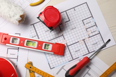 Photo of Flat lay composition with building level and other construction tools on white wooden table