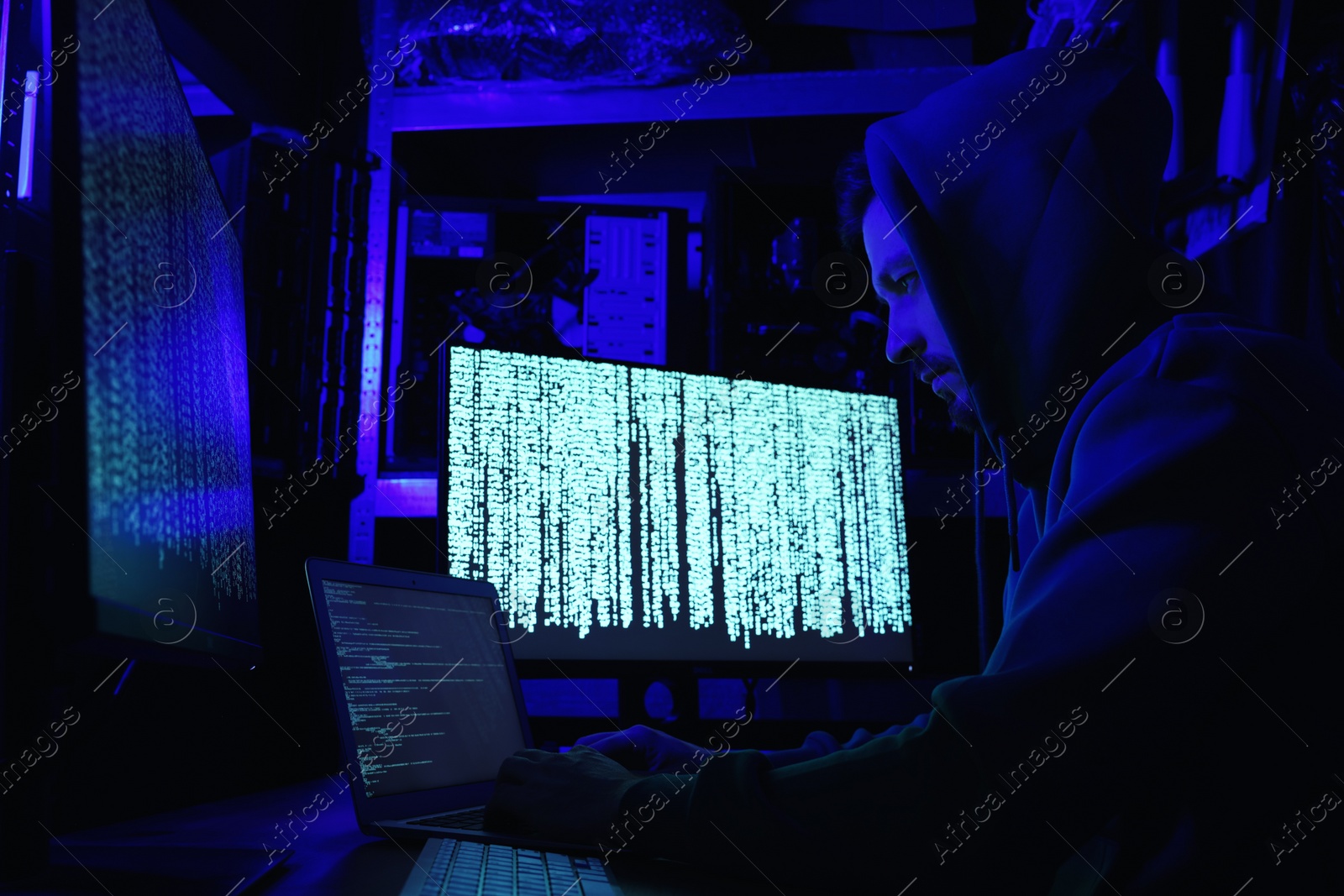 Photo of Hacker working with computers in dark room. Cyber attack