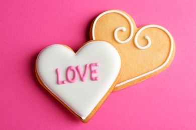 Photo of Decorated heart shaped cookies on color background, top view. Valentine's day treat