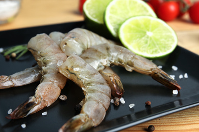 Photo of Fresh raw shrimps on plate, closeup view