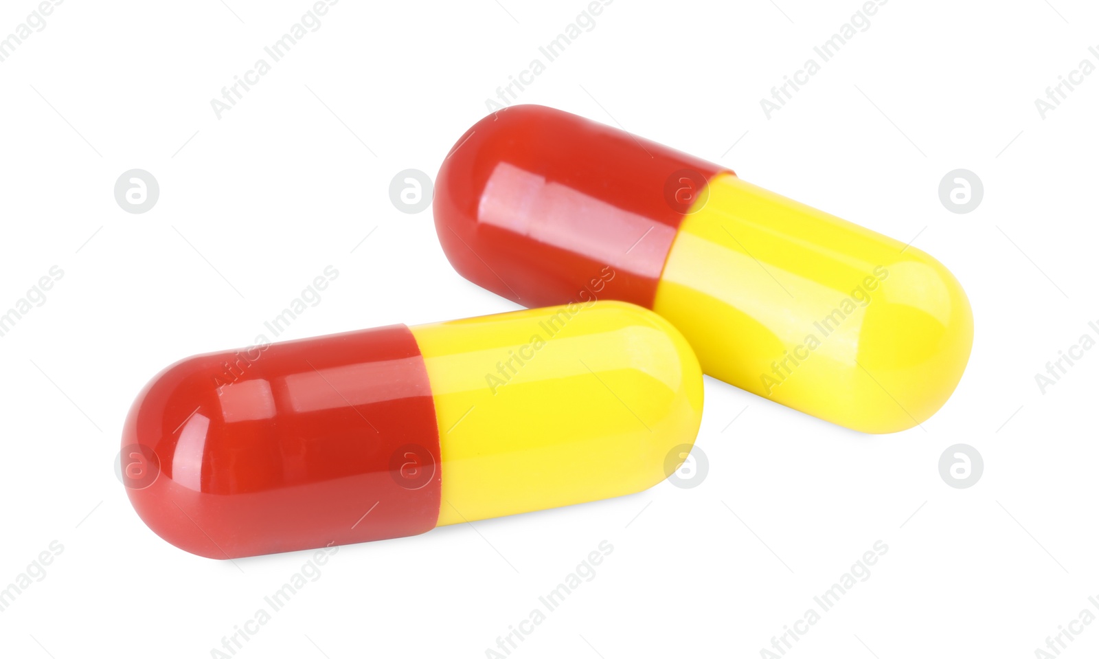 Photo of Two antibiotic pills isolated on white. Medicinal treatment