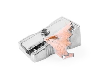 Metal sharpener with pencil shavings on white background