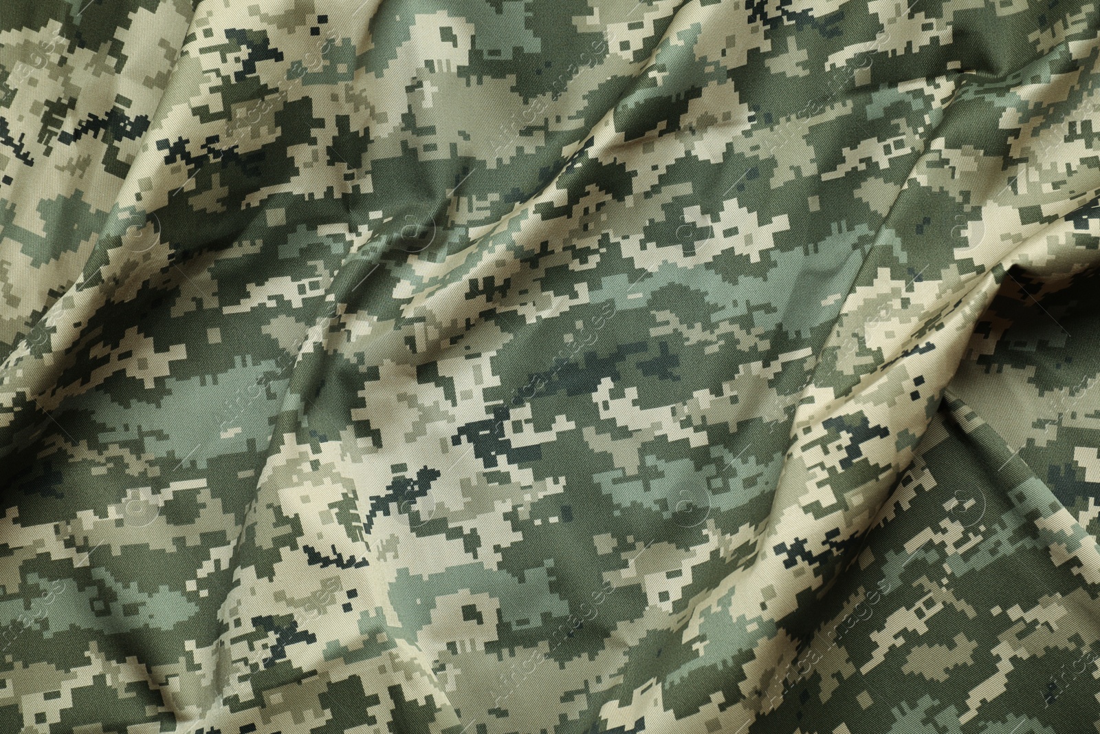 Photo of Texture of crumpled camouflage fabric as background, top view