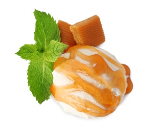 Photo of Scoop of delicious ice cream with mint, caramel sauce and candies on white background, top view