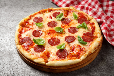 Hot delicious pepperoni pizza on grey table