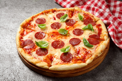 Photo of Hot delicious pepperoni pizza on grey table