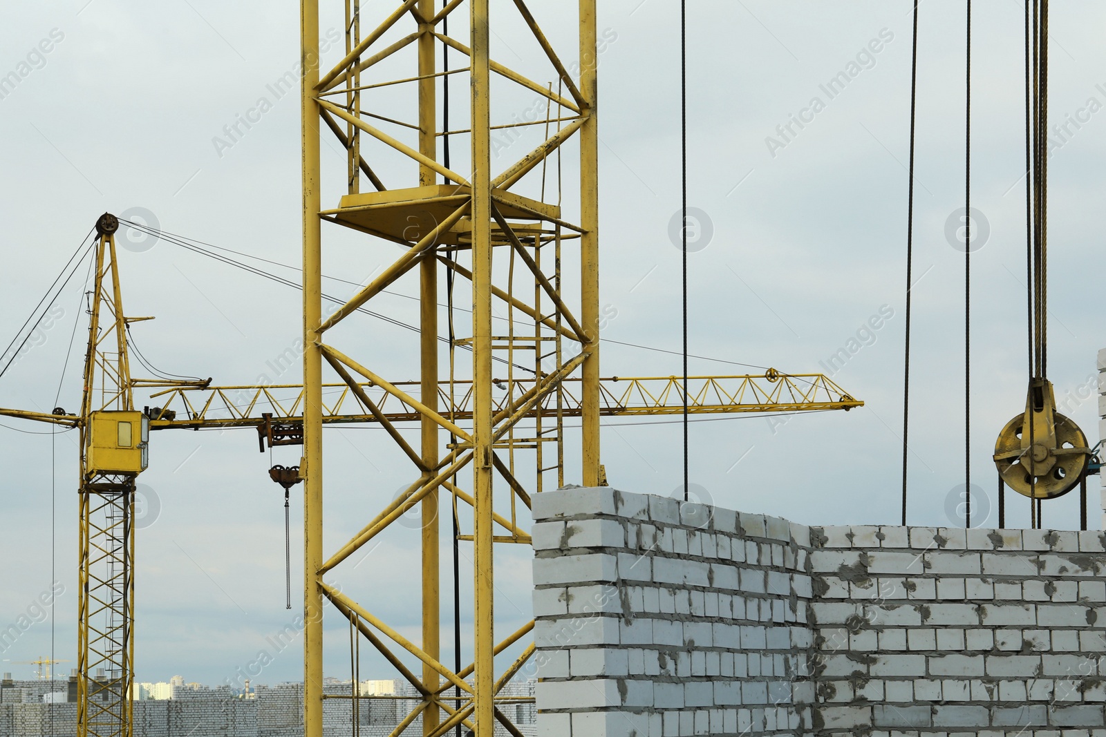 Photo of Construction site with tower crane near unfinished building