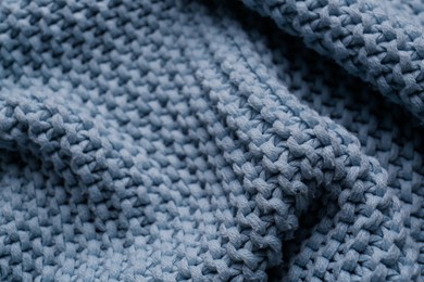 Photo of Beautiful light blue knitted fabric as background, closeup