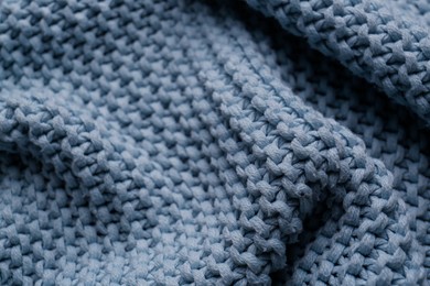 Beautiful light blue knitted fabric as background, closeup