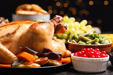 Traditional Thanksgiving day feast with delicious cooked turkey and other seasonal dishes served on table, closeup