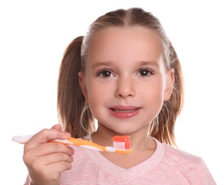 Photo of Little girl holding toothbrush with paste on white background