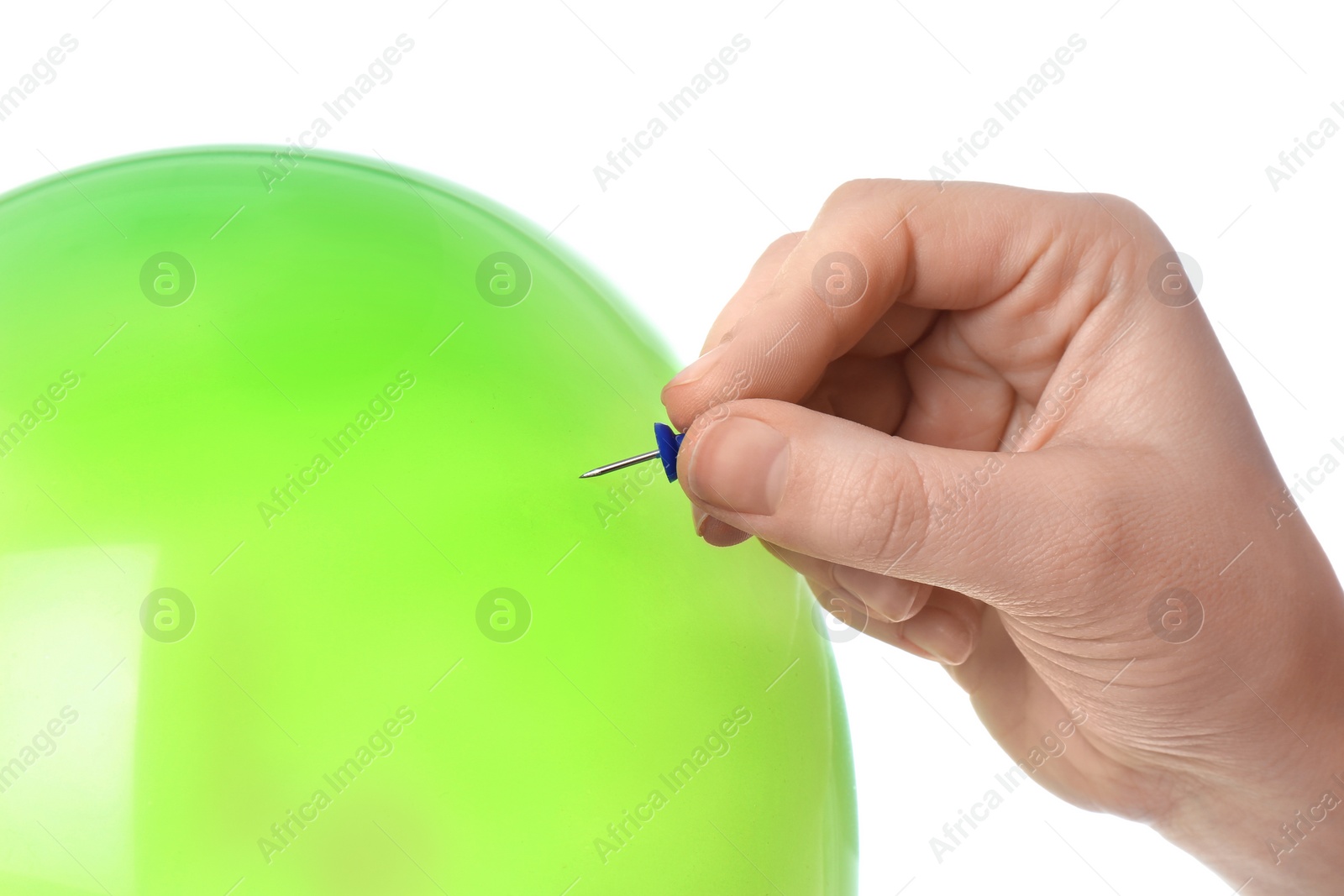 Photo of Woman piercing green balloon on white background, closeup