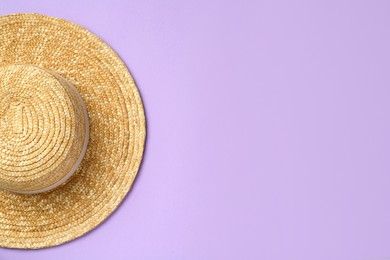 Photo of Stylish straw hat on violet background, top view. Space for text