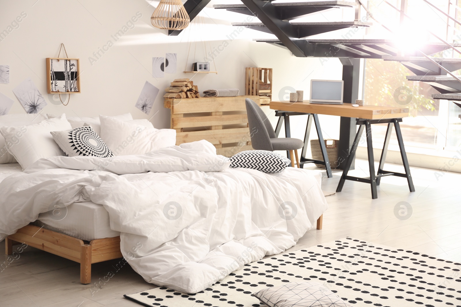 Photo of Elegant interior of bedroom with workplace under stairs