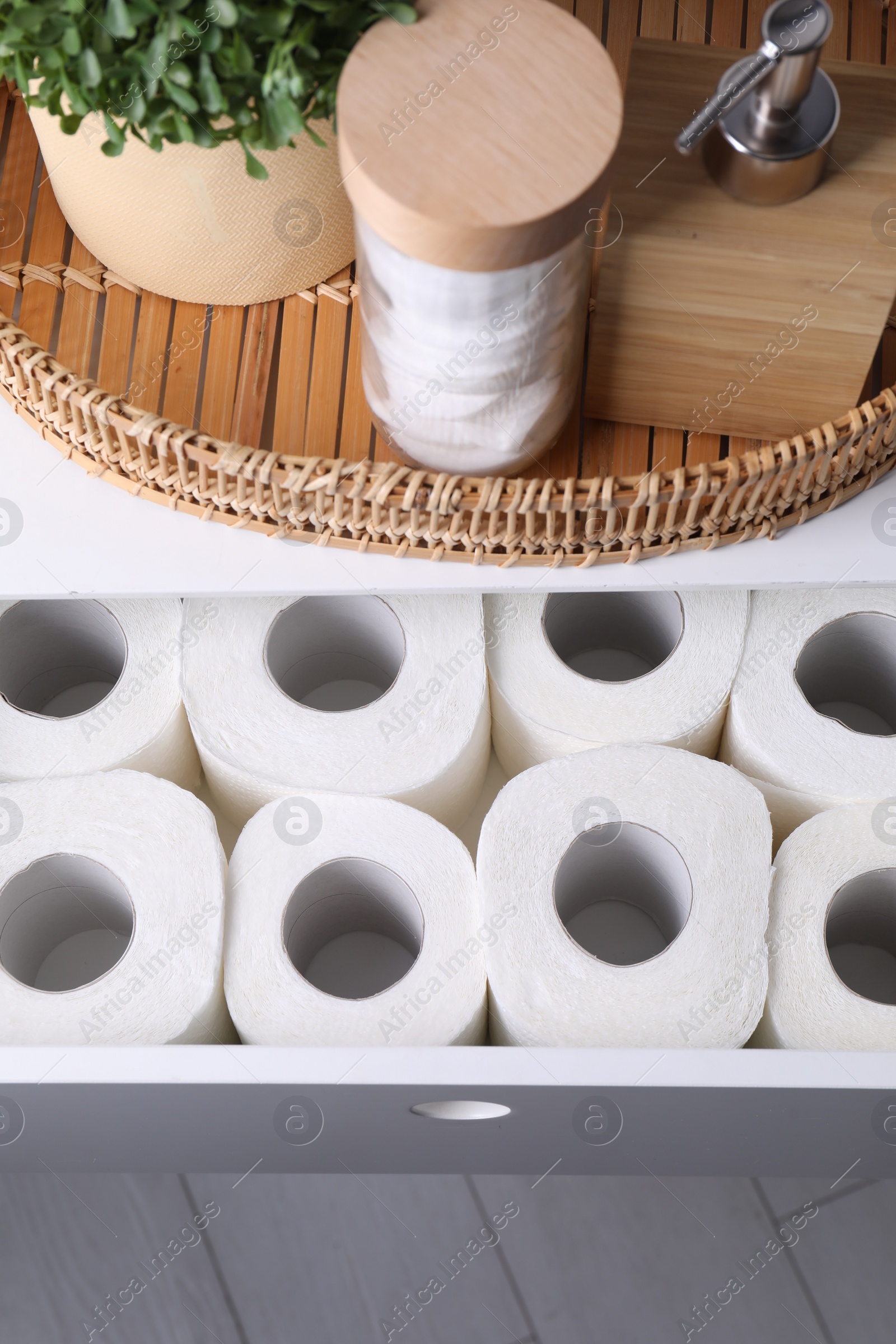 Photo of Many toilet paper rolls in white drawer indoors, top view