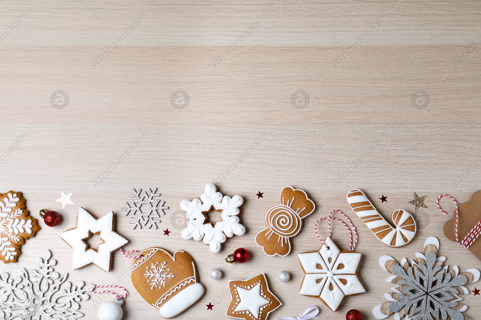 Photo of Decorated Christmas cookies on wooden table, flat lay. Space for text