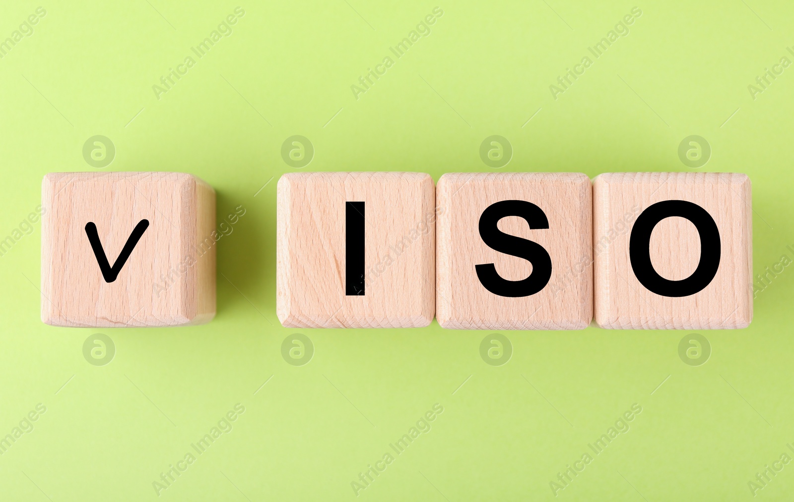 Photo of International Organization for Standardization. Wooden cubes with check mark and abbreviation ISO on light green background, flat lay