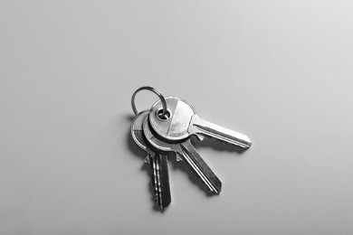 Keys on white background, top view. Real estate agent services