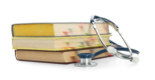 Photo of Stethoscope and stack of books isolated on white