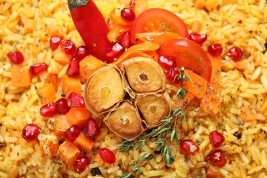 Photo of Tasty rice pilaf with vegetables as background, closeup