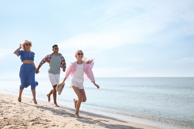 Photo of Happy family at beach on sunny summer day