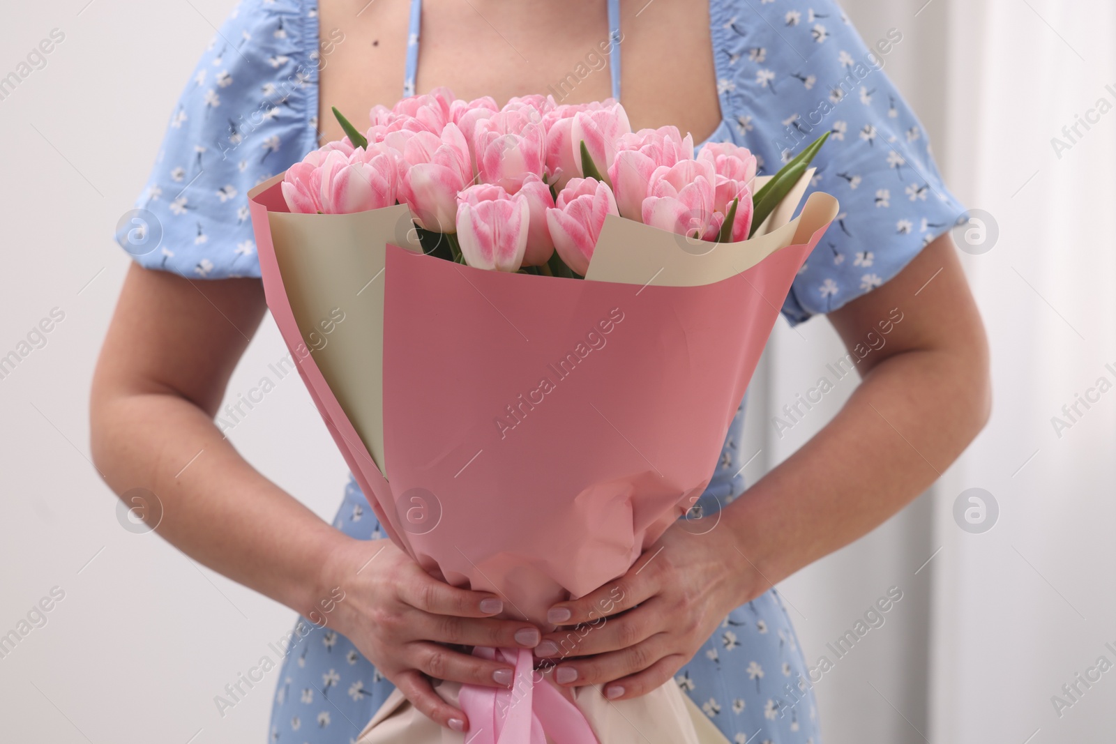 Photo of Woman with bouquet of beautiful fresh tulips on blurred background, closeup