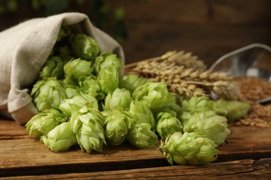 Fresh green hops on wooden table, closeup