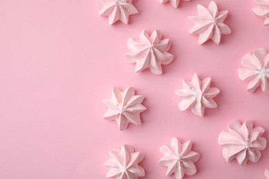 Photo of Many tasty meringue cookies on pink background, flat lay. Space for text