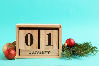 Photo of Wooden block calendar and decor on color background. Christmas countdown