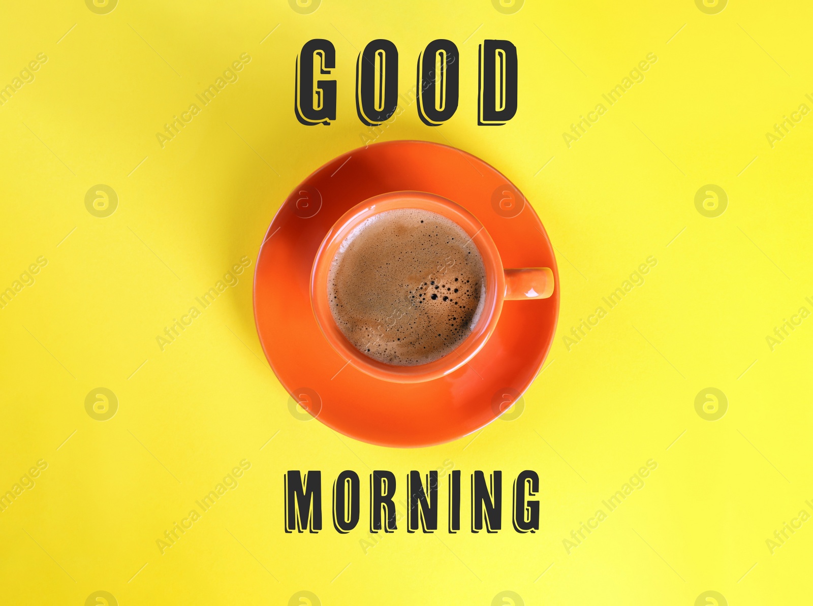 Image of Good Morning. Cup of tasty coffee on yellow background, top view