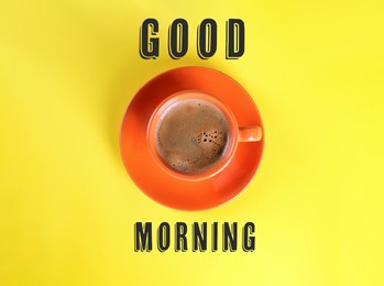Image of Good Morning. Cup of tasty coffee on yellow background, top view