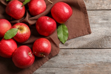 Photo of Fresh ripe red apples on wooden background