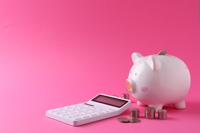 Photo of Financial savings. Piggy bank, coins and calculator on pink background, space for text