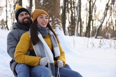 Portrait of happy young couple outdoors on winter day